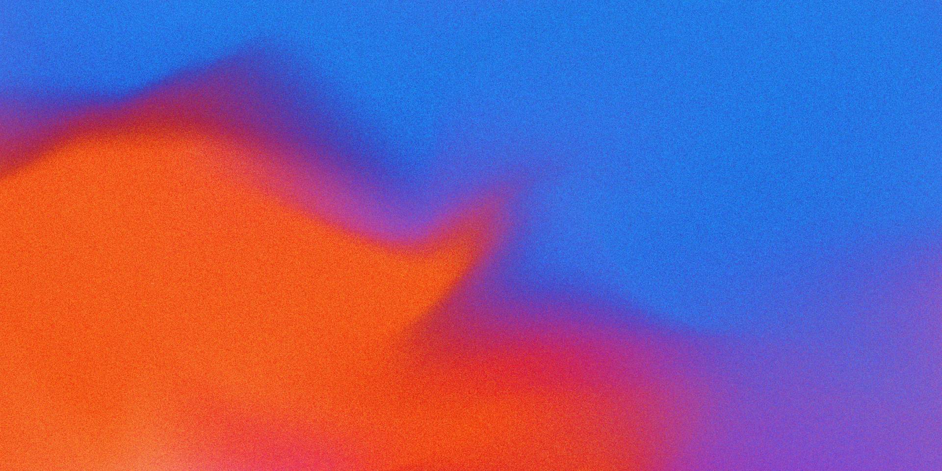 A vibrant abstract image featuring a blend of bold orange and red shapes on the left, fading into a bright blue background on the right, with soft, grainy texture throughout.