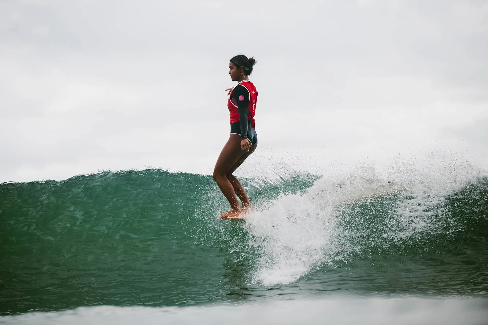 Surfer riding a green wave